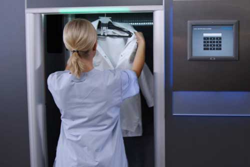A nurse collecting new workwear from a high-quality digitalized logistics system.